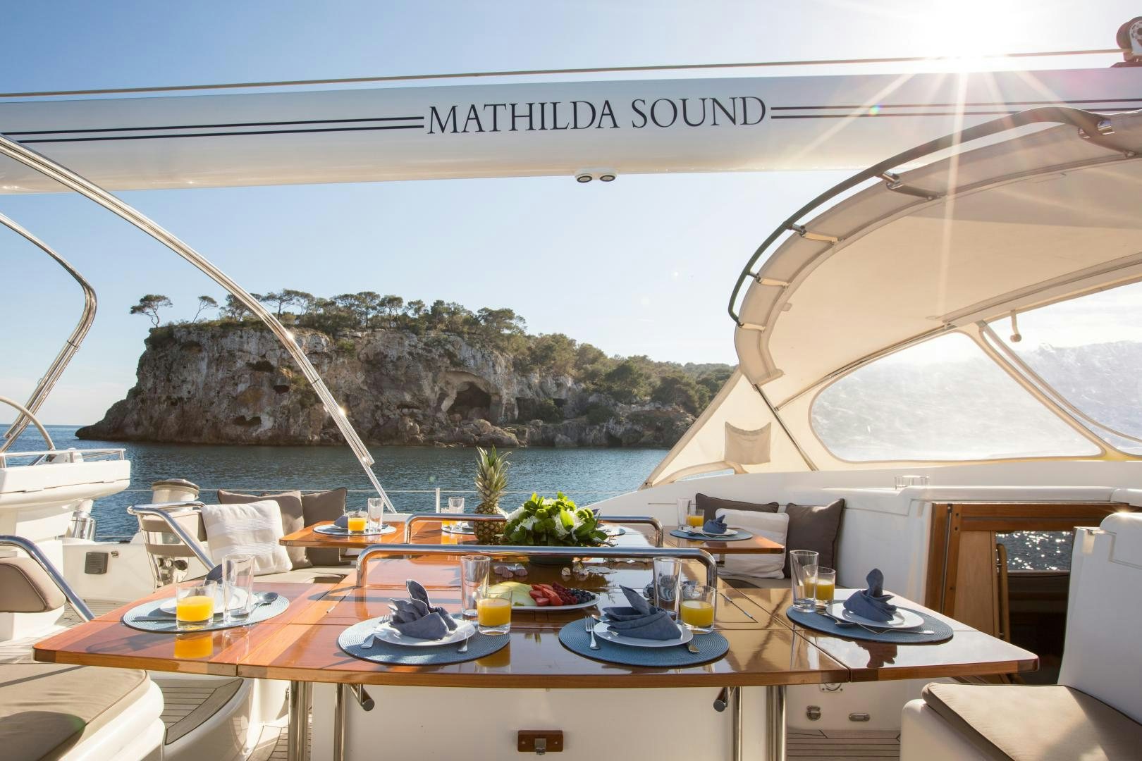 a restaurant with a view of the ocean and the mountains aboard MATHILDA SOUND Yacht for Sale