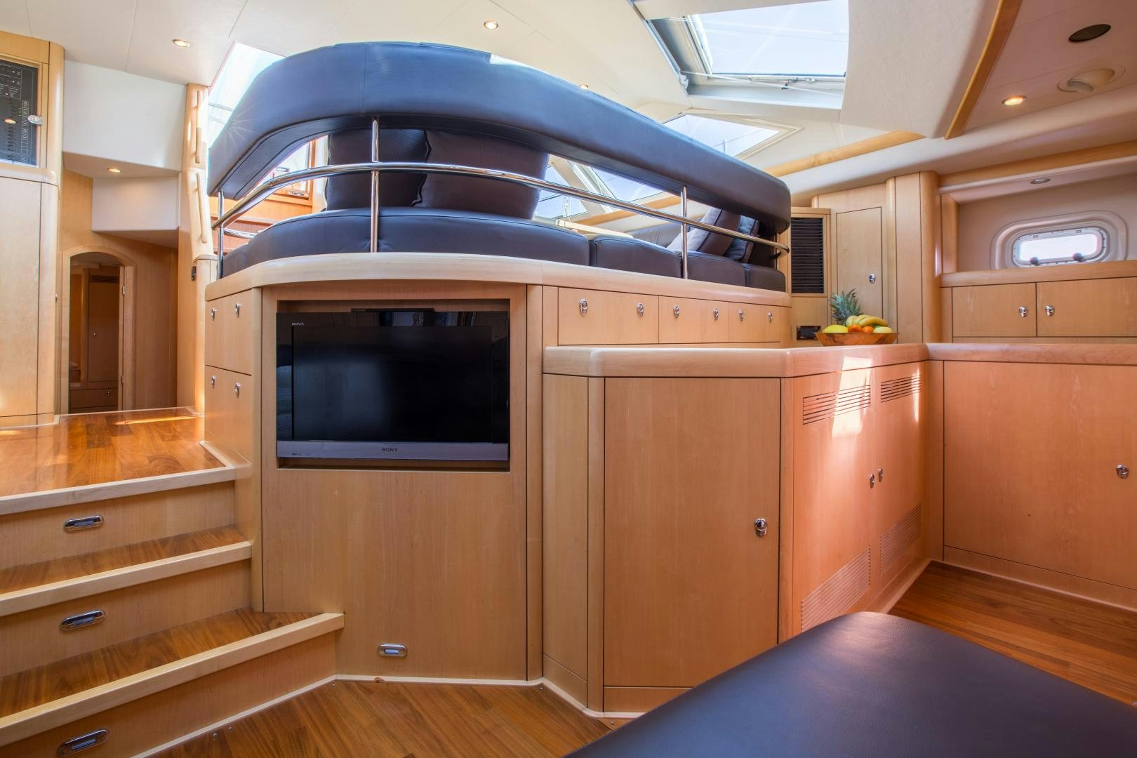 a wooden cabin with a large wood cabinet and a large tv aboard MATHILDA SOUND Yacht for Sale