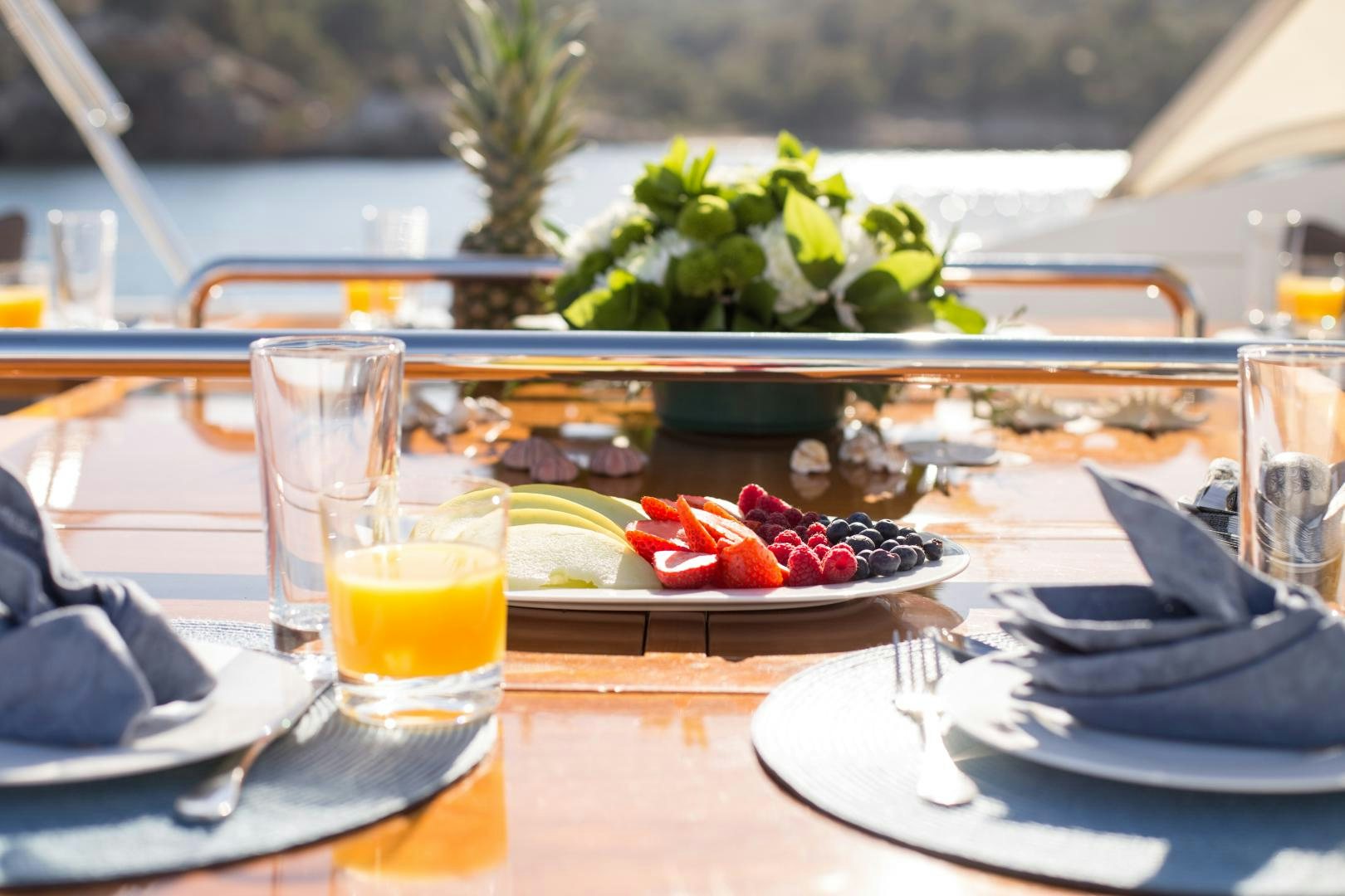a table with plates of food and glasses on it aboard MATHILDA SOUND Yacht for Sale