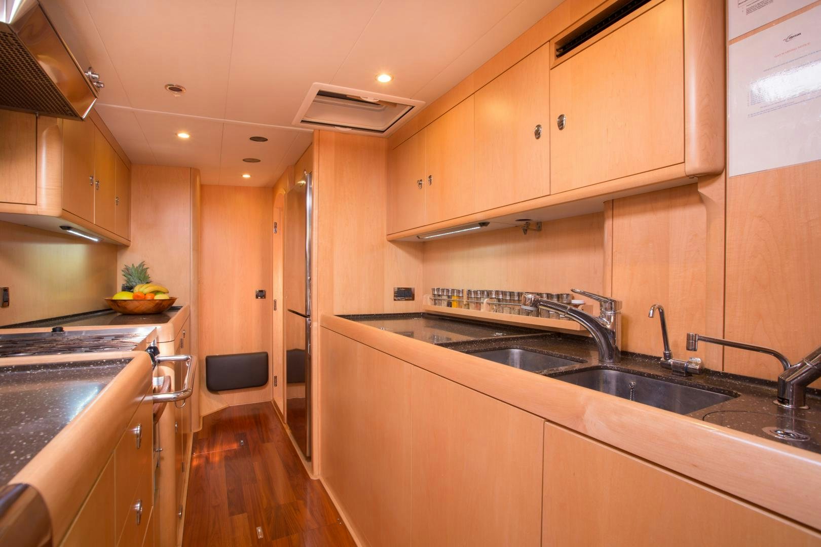 a kitchen with wooden cabinets aboard MATHILDA SOUND Yacht for Sale