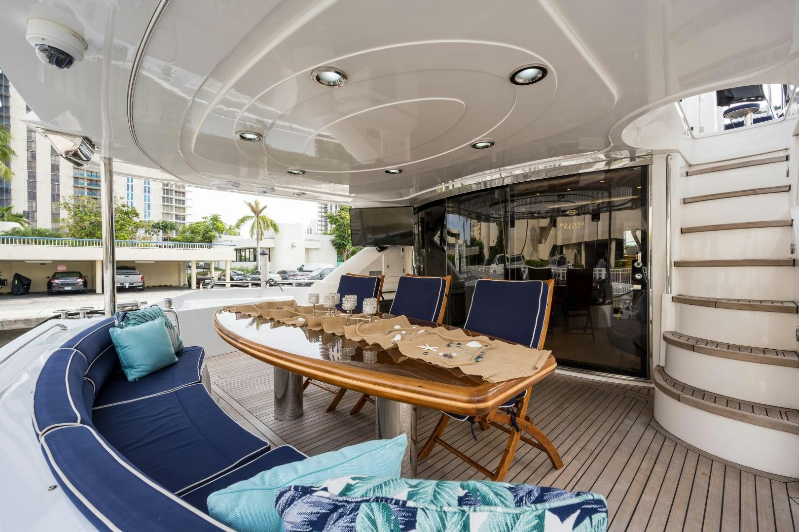 a large outdoor lounge area with a table and chairs aboard SS ARTS Yacht for Sale