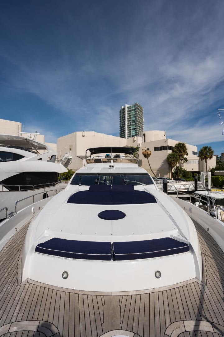 a white yacht in a dock aboard SS ARTS Yacht for Sale