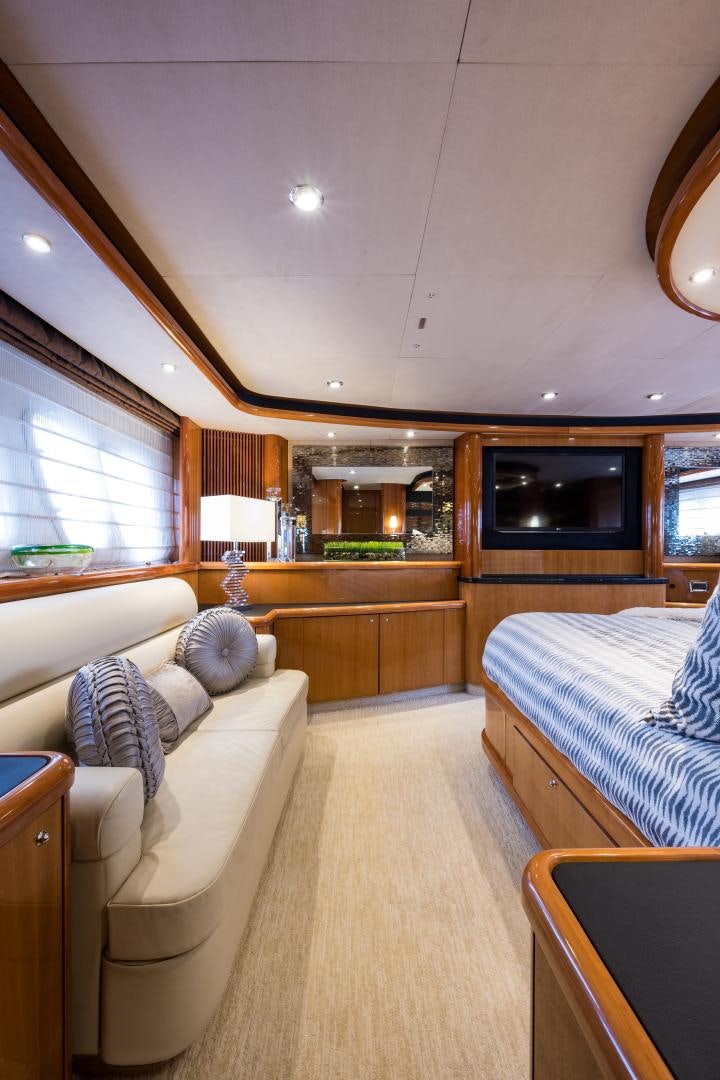 a bedroom with a bed and a couch aboard SS ARTS Yacht for Sale