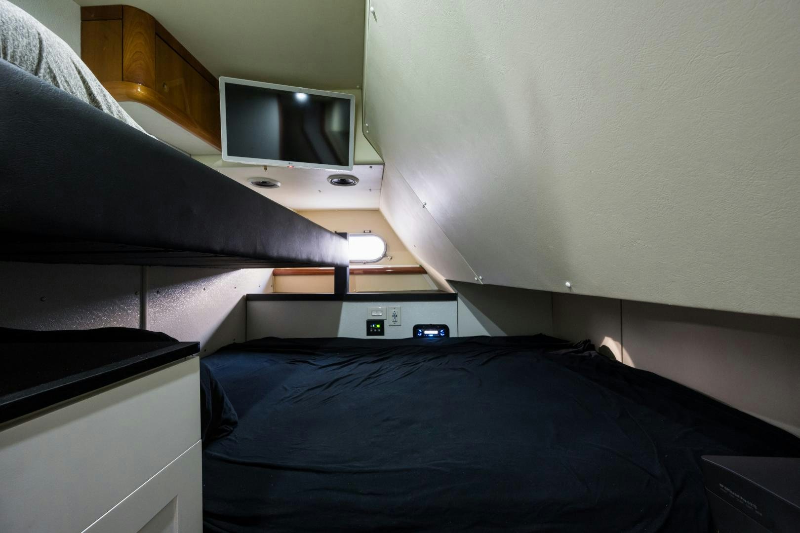 a bed with a television on top of it aboard SS ARTS Yacht for Sale