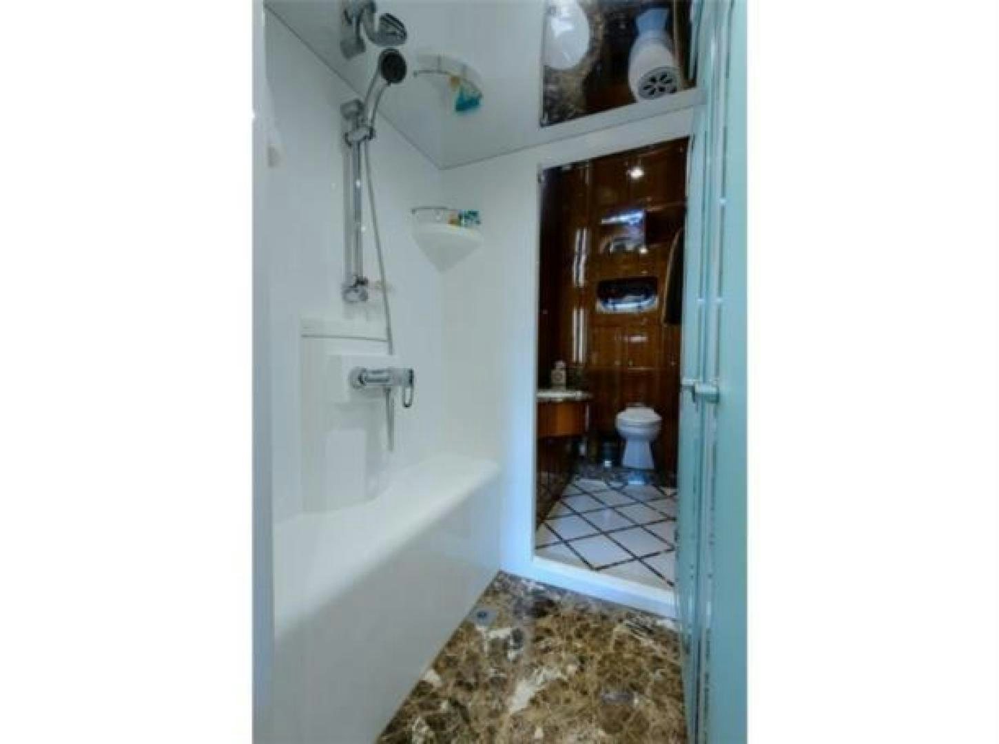 a bathroom with a sink and toilet aboard PRIMETIME Yacht for Sale