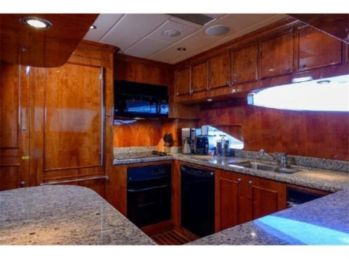 a kitchen with wooden cabinets aboard PRIMETIME Yacht for Sale