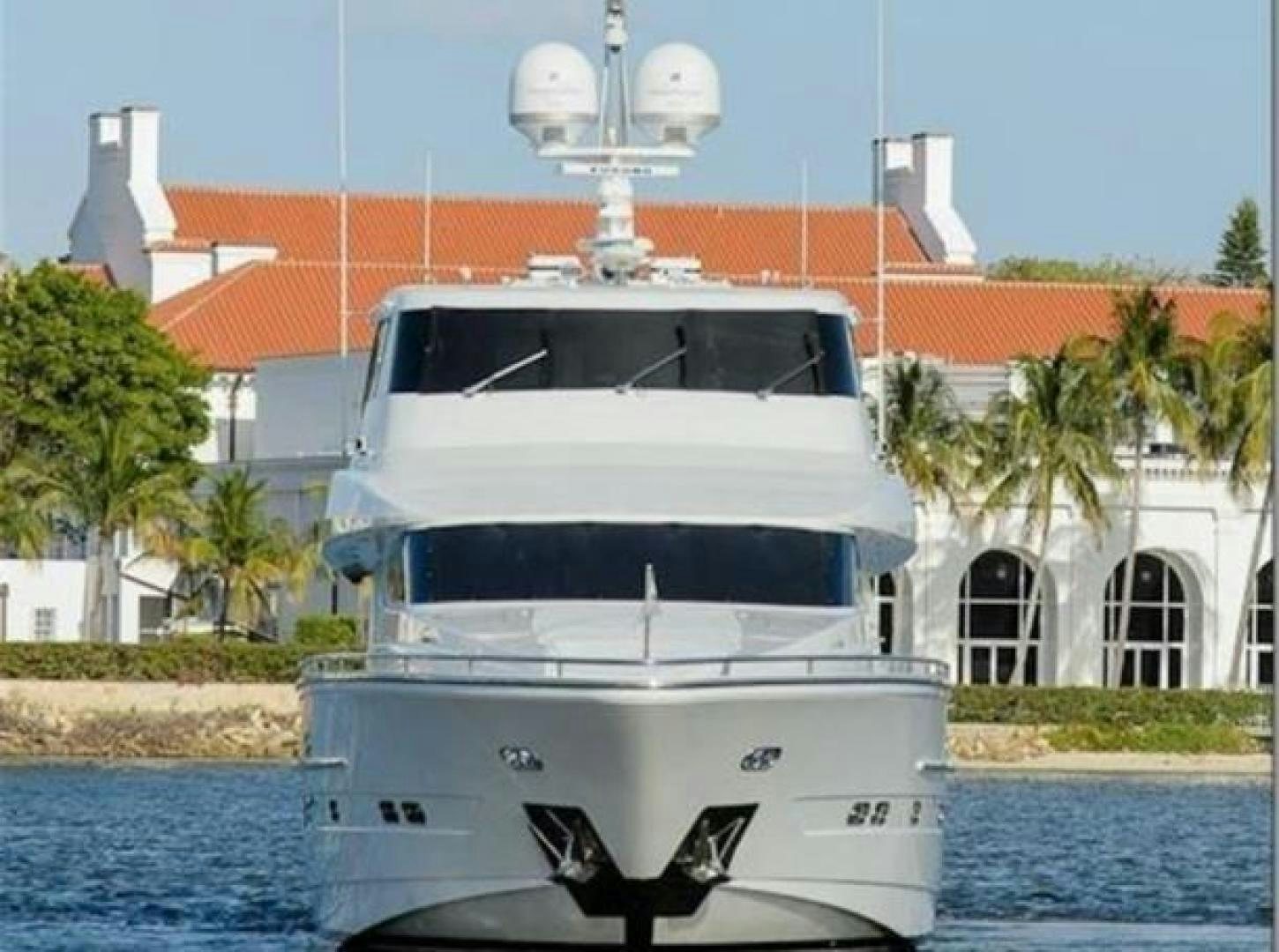 a white boat in front of a building aboard PRIMETIME Yacht for Sale