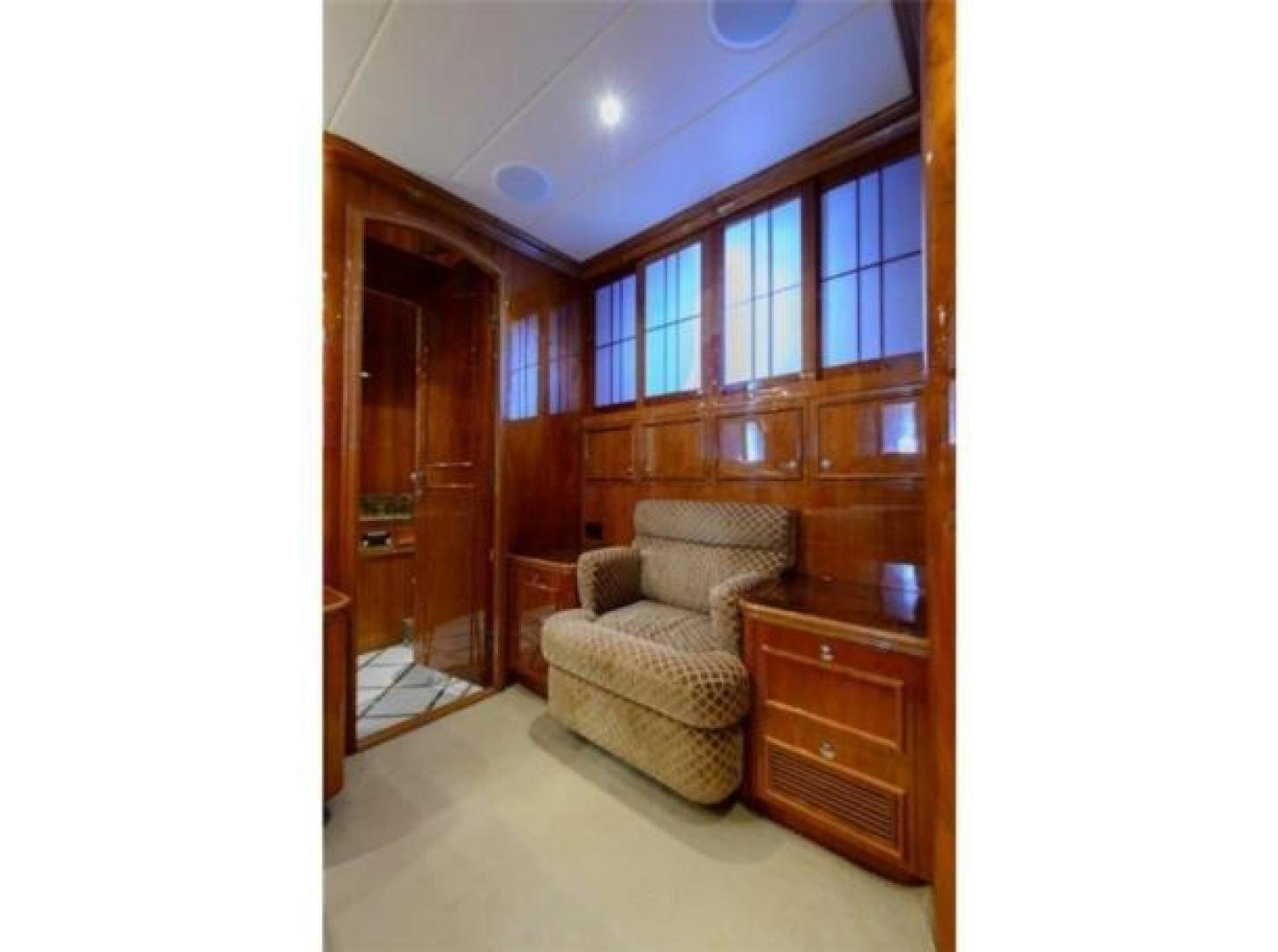 a living room with a chair and a couch aboard PRIMETIME Yacht for Sale