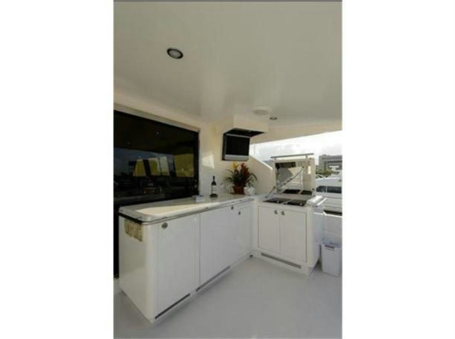 a kitchen with white cabinets aboard PRIMETIME Yacht for Sale