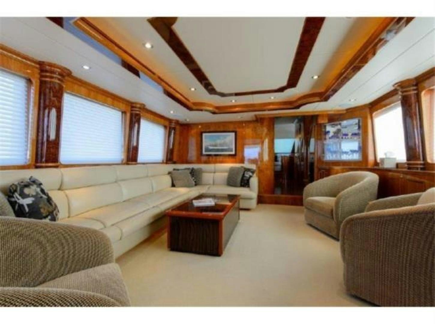 a living room with a couch and a table aboard PRIMETIME Yacht for Sale