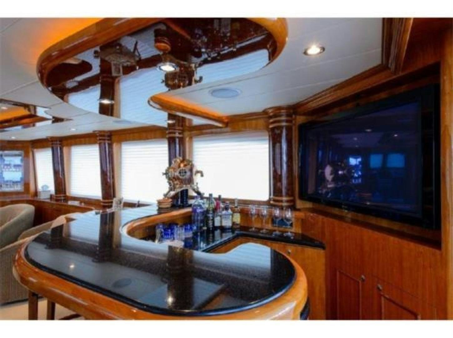 a bar with a bar and a table in the middle aboard PRIMETIME Yacht for Sale