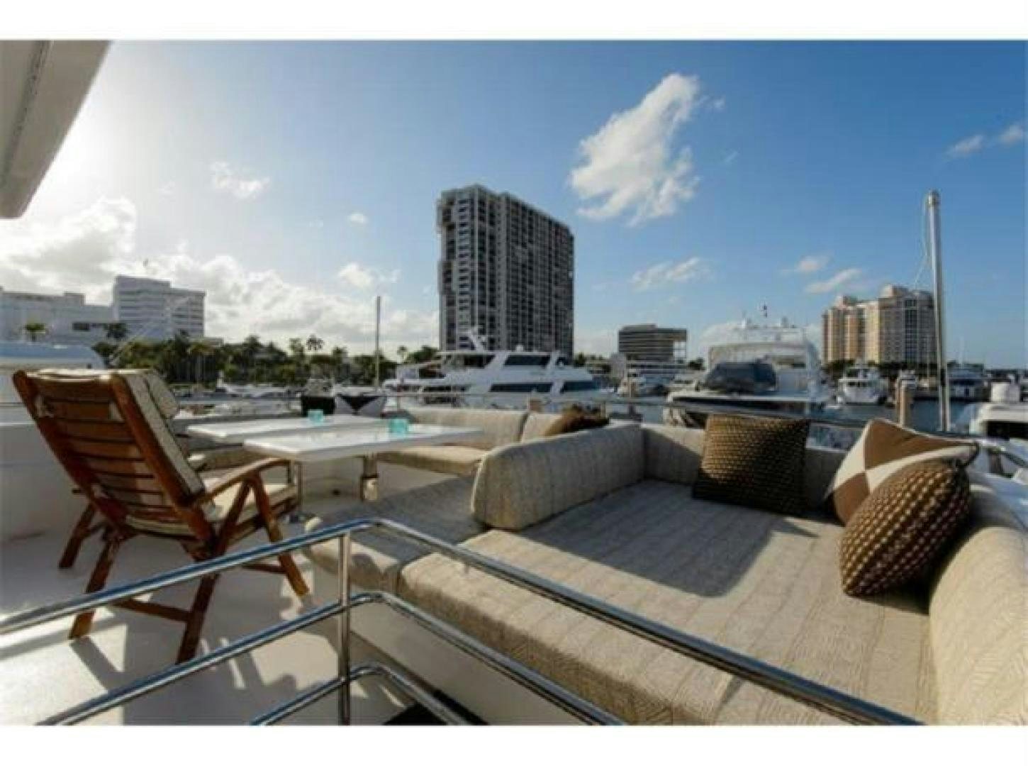 a balcony with a view of a city and a body of water aboard PRIMETIME Yacht for Sale