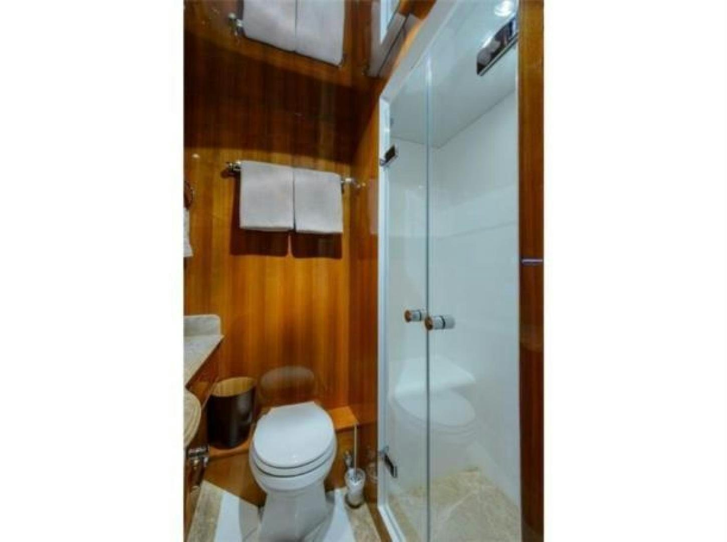 a bathroom with a glass shower aboard PRIMETIME Yacht for Sale