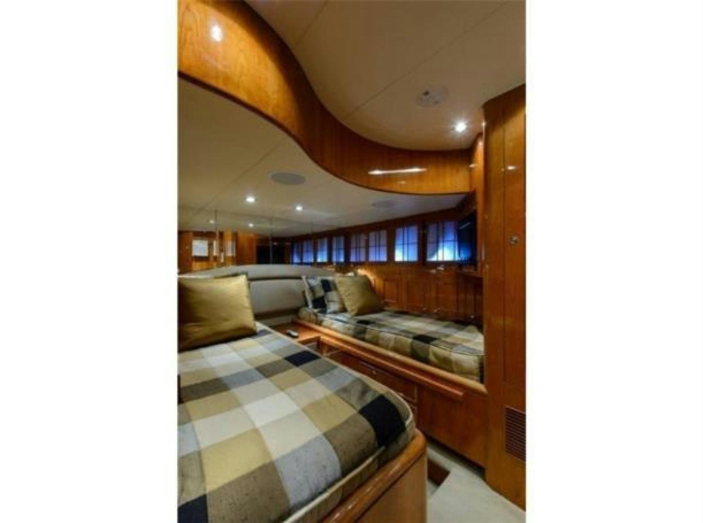 a room with a bed and a wood door aboard PRIMETIME Yacht for Sale