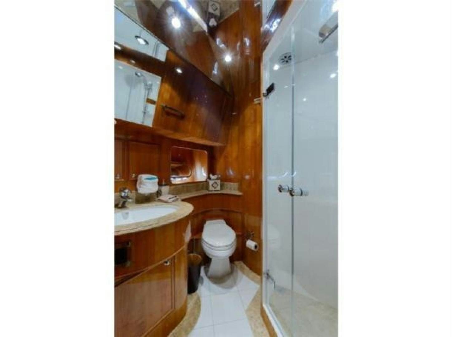 a bathroom with a toilet and a sink aboard PRIMETIME Yacht for Sale