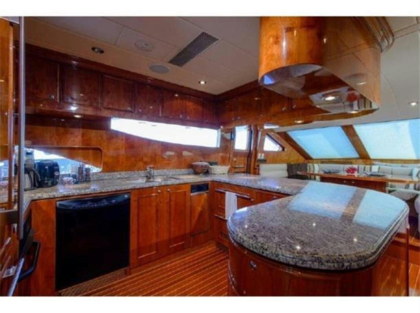 a kitchen with wooden cabinets aboard PRIMETIME Yacht for Sale