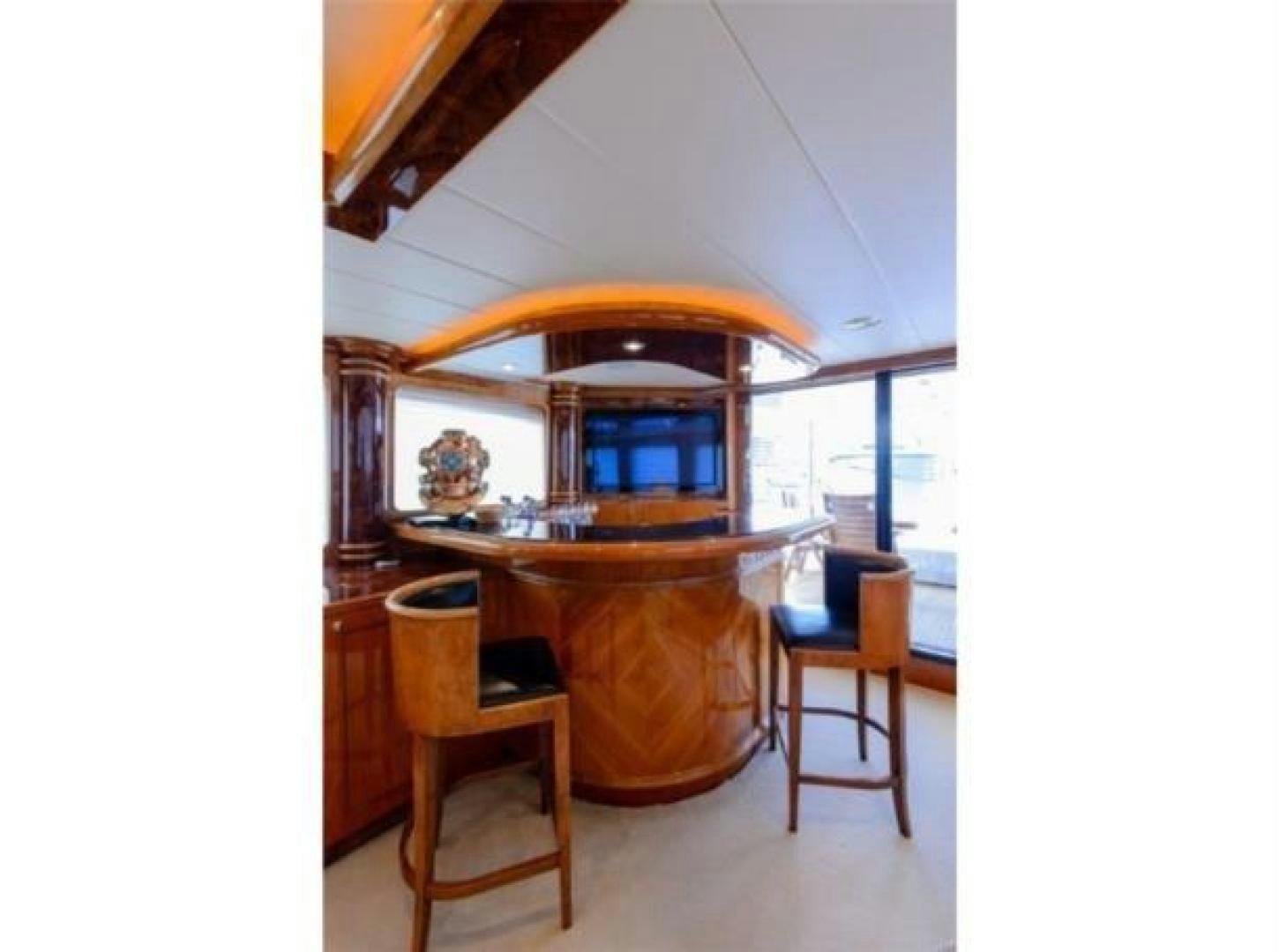 a large wooden table with chairs around it aboard PRIMETIME Yacht for Sale