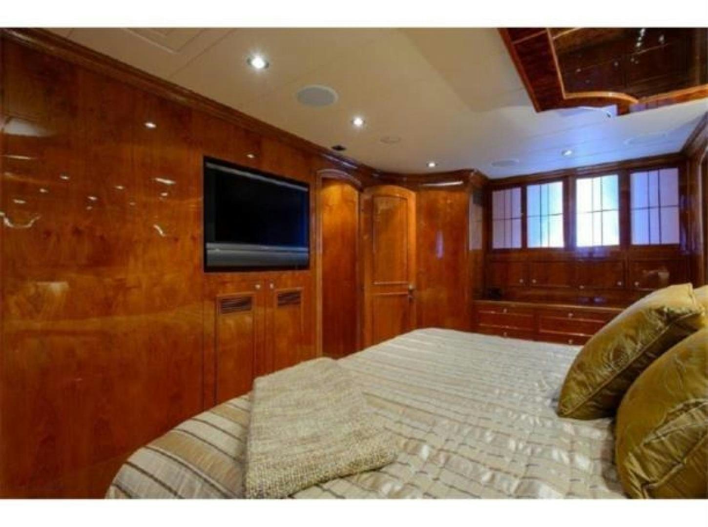 a room with a tv and a bed aboard PRIMETIME Yacht for Sale