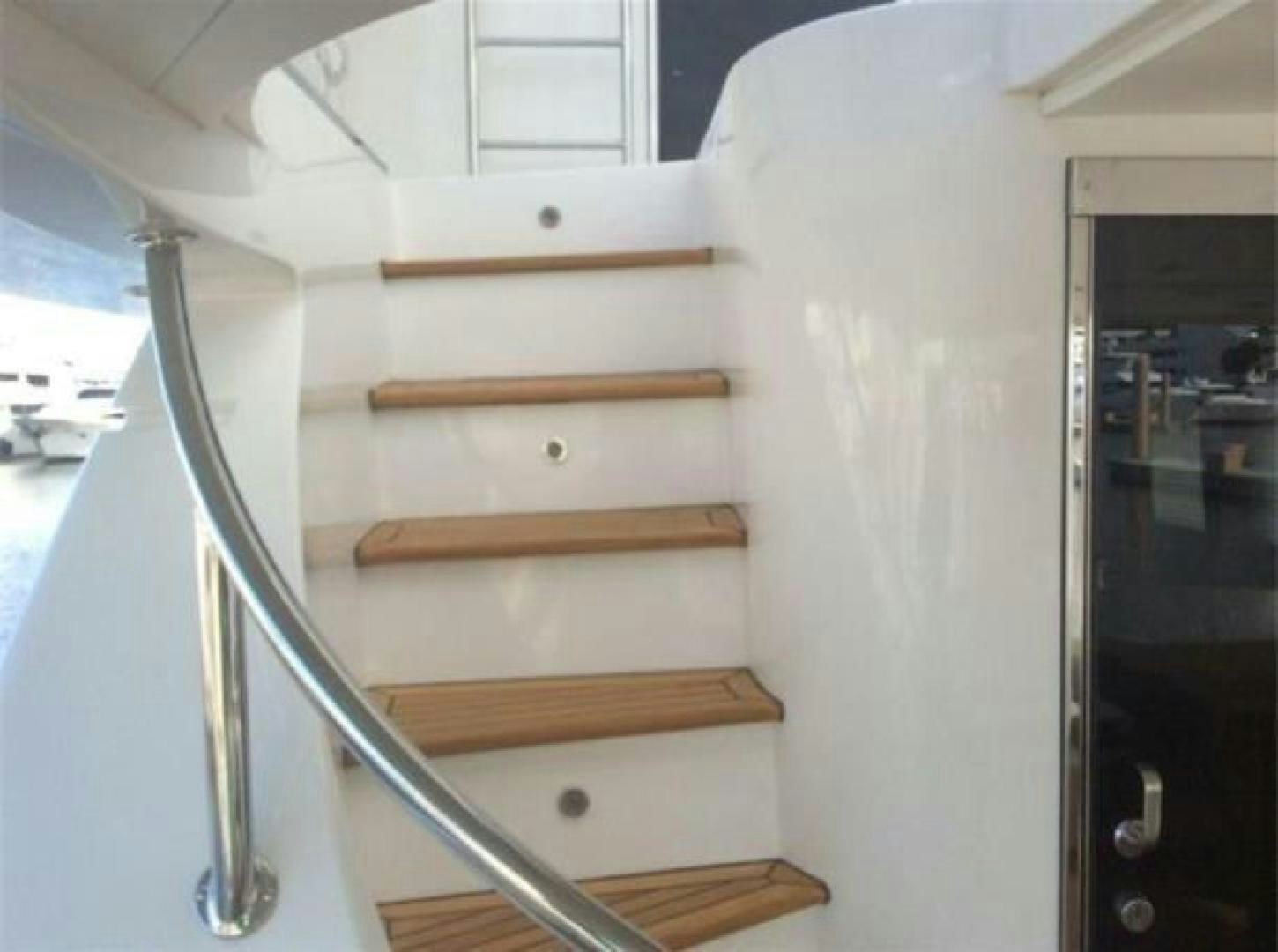 a wooden staircase in a house aboard PRIMETIME Yacht for Sale