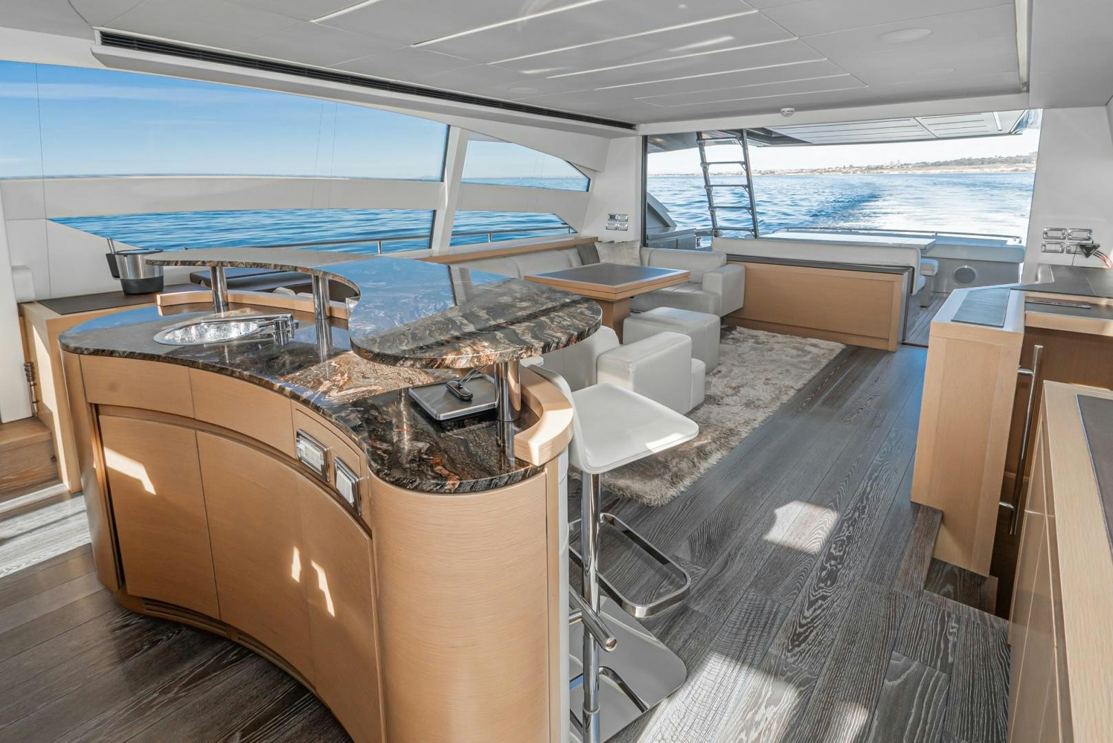 a room with a large window and a table with chairs and a large pool of water aboard NO NAME Yacht for Sale