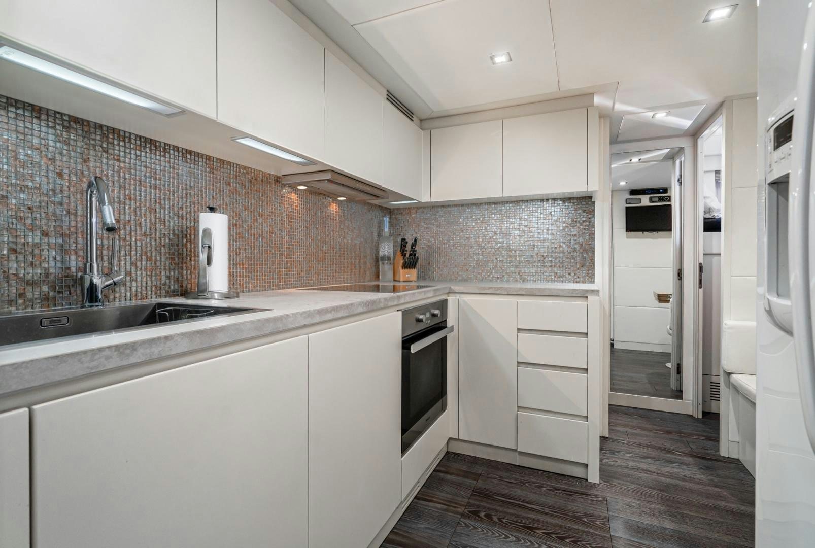 a kitchen with white cabinets aboard NO NAME Yacht for Sale