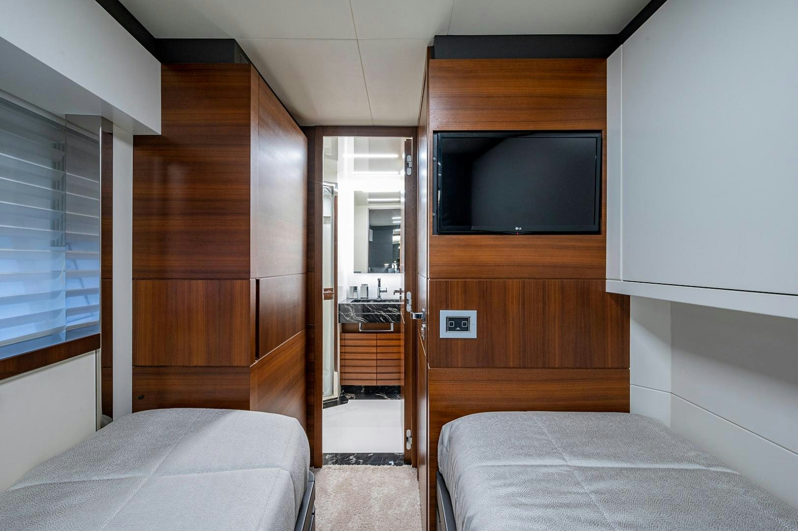 a room with a bed and a television aboard No Name Yacht for Sale
