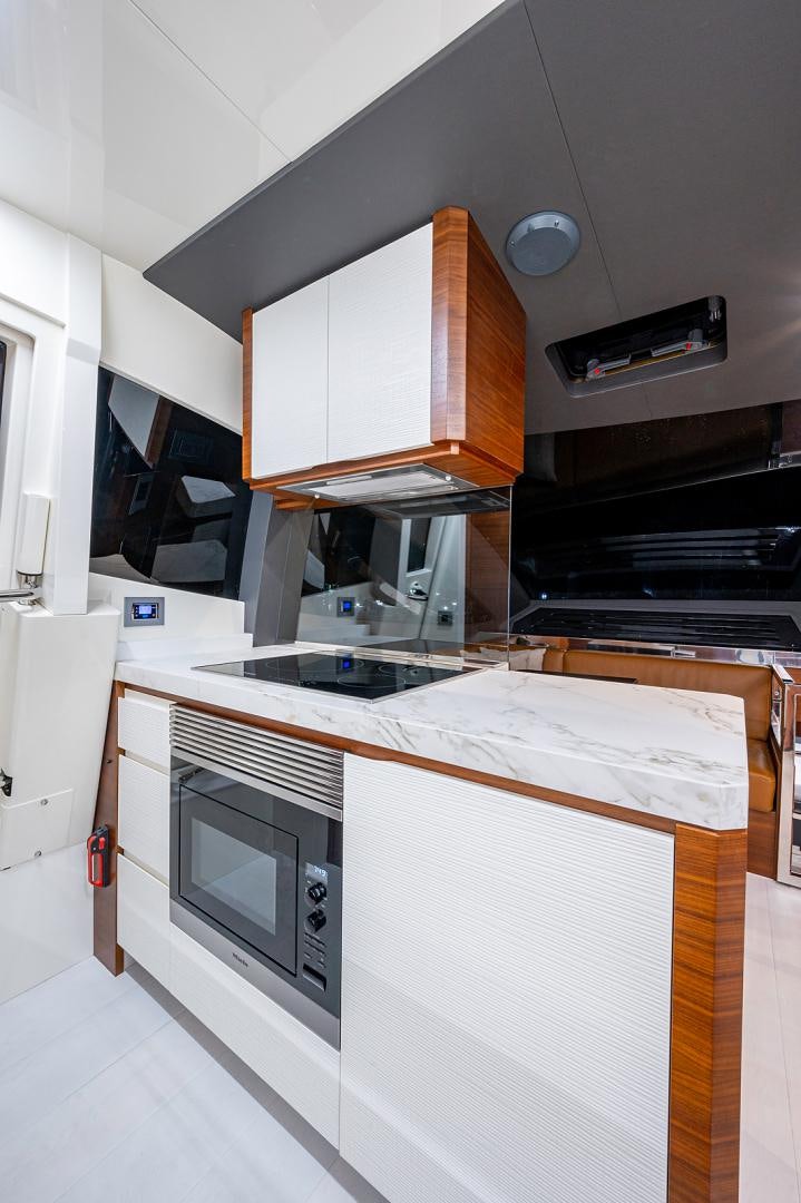 a kitchen with white cabinets aboard No Name Yacht for Sale