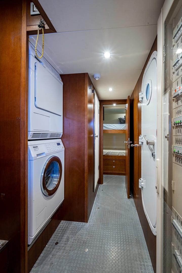 a hallway with a washing machine and dryer aboard No Name Yacht for Sale