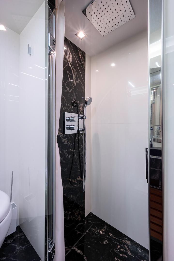 a shower with a black wall aboard No Name Yacht for Sale