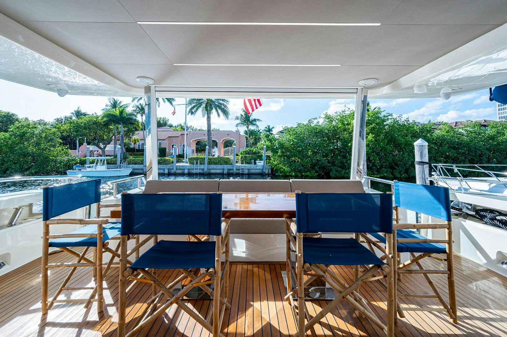 a deck with chairs and tables aboard No Name Yacht for Sale