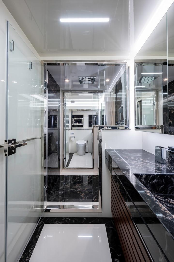 a bathroom with a glass shower aboard No Name Yacht for Sale