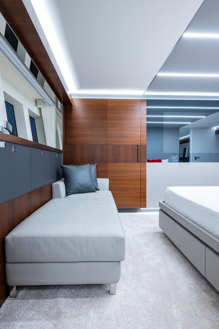 a room with a bed and a wood wall aboard No Name Yacht for Sale