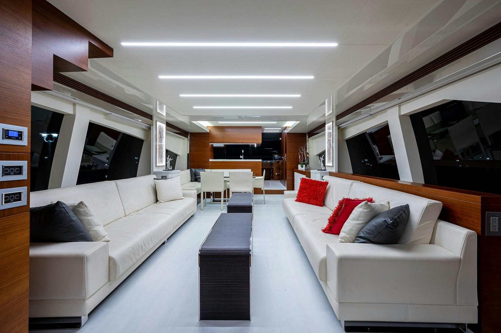 a room with white couches and a table aboard No Name Yacht for Sale