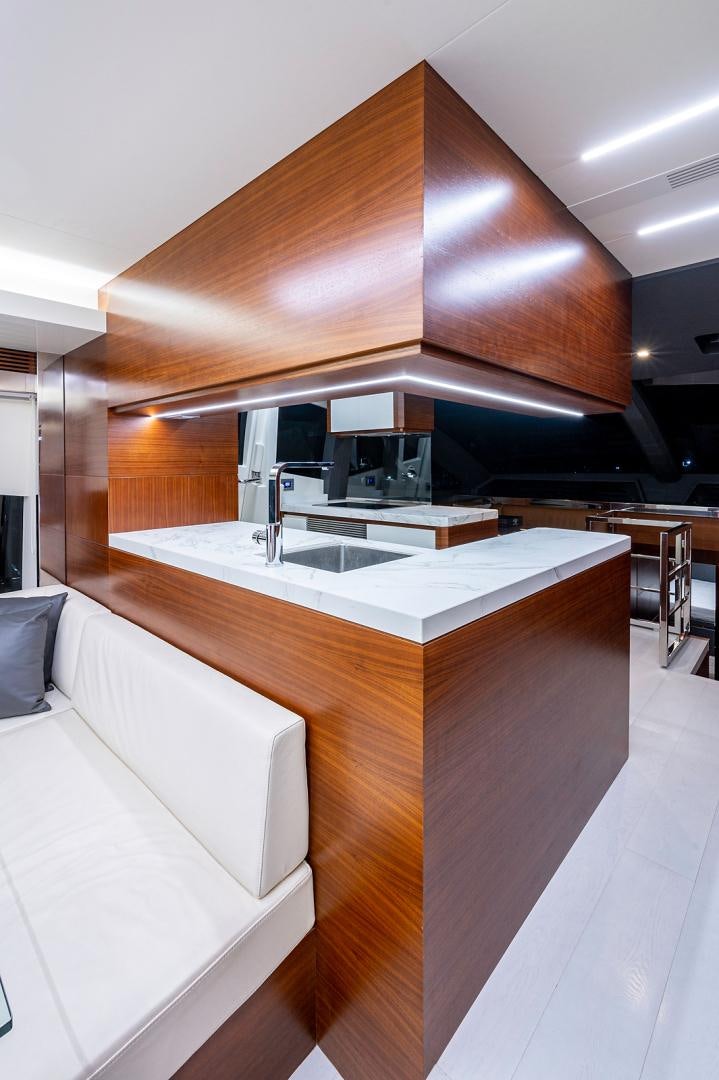 a modern kitchen with white cabinets aboard No Name Yacht for Sale