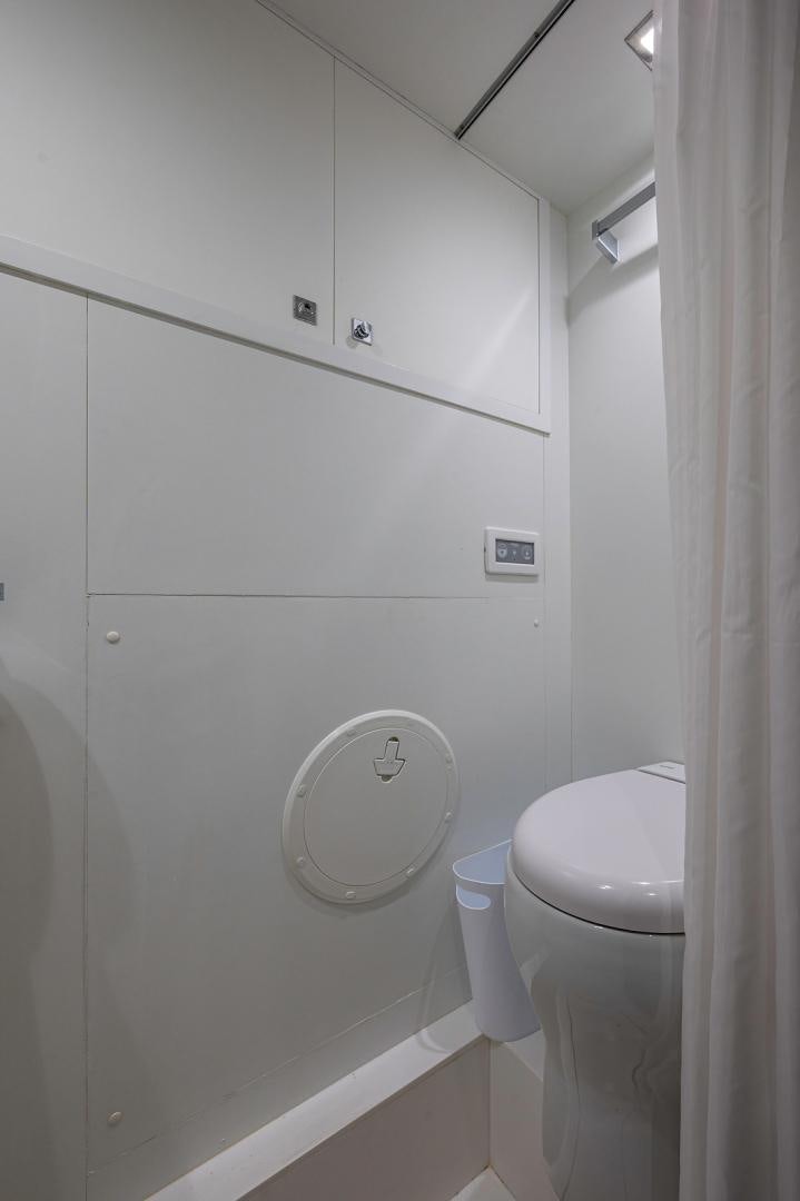 a bathroom with a toilet and a urinal aboard No Name Yacht for Sale