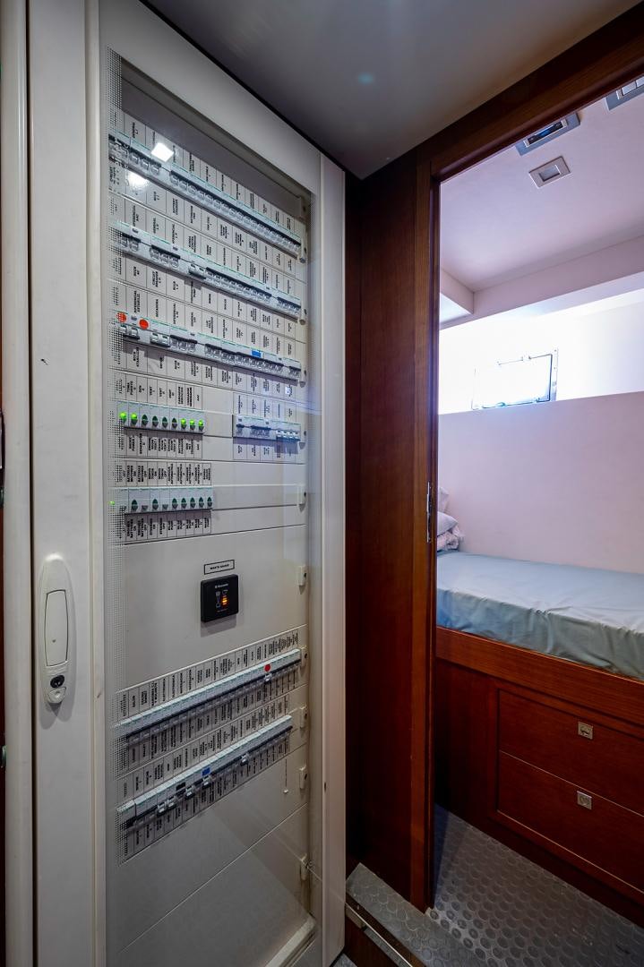 a room with a bed and a book shelf aboard No Name Yacht for Sale