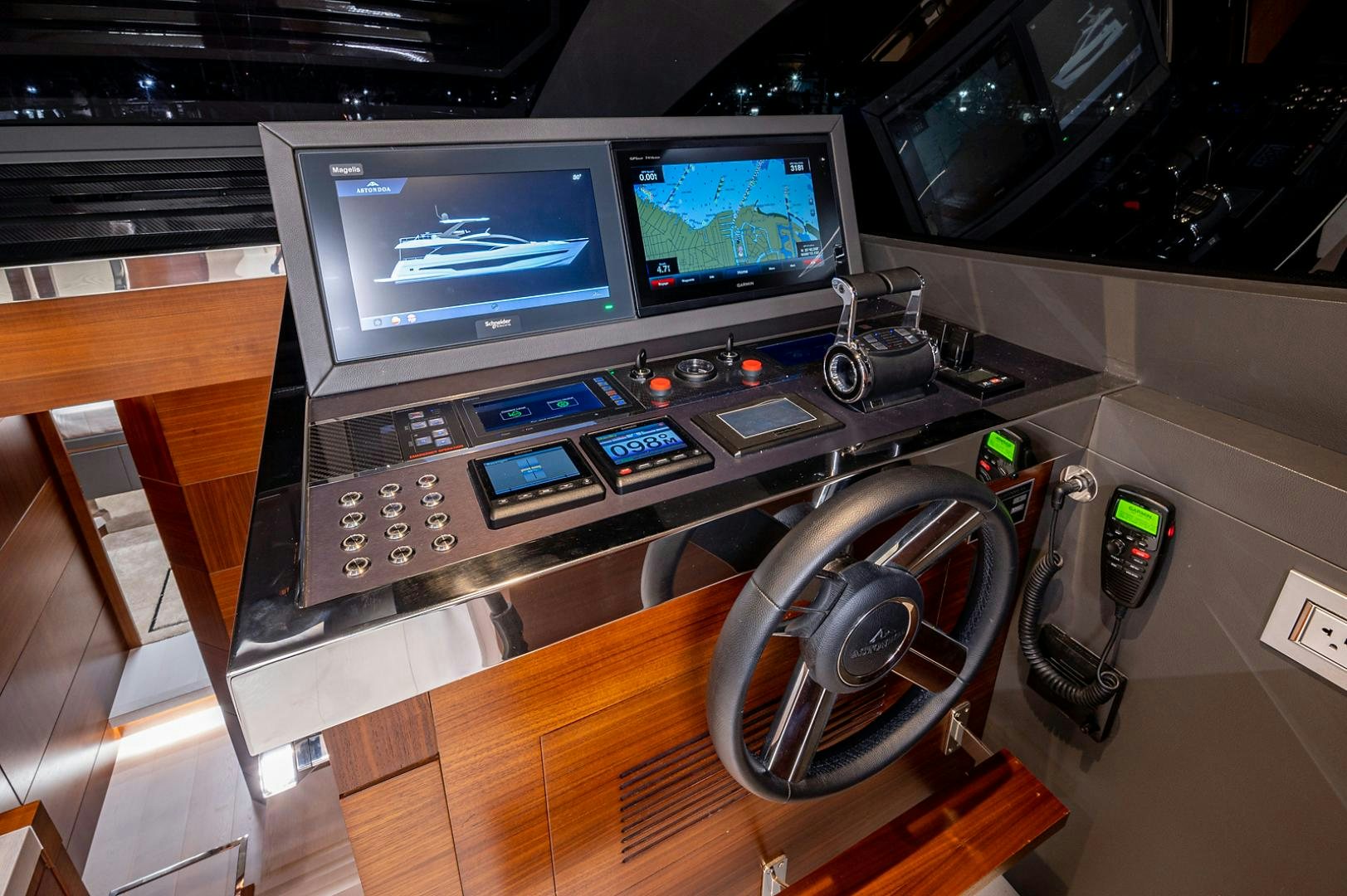 a desk with a television and a computer on it aboard No Name Yacht for Sale