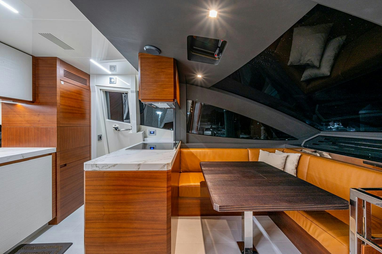 a kitchen with a table and a tv on the wall aboard No Name Yacht for Sale