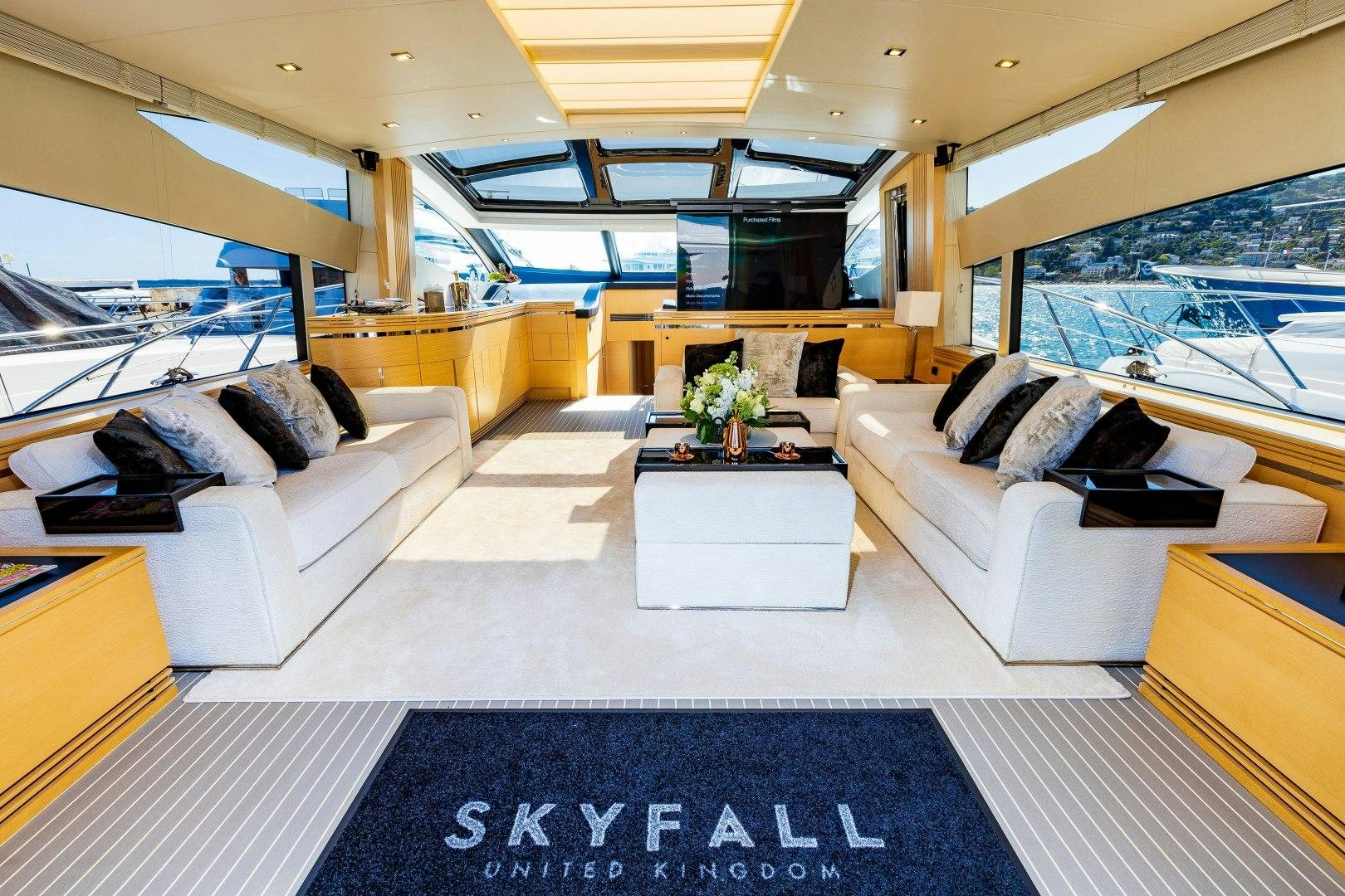 a living room with a blue rug aboard SKYFALL Yacht for Sale