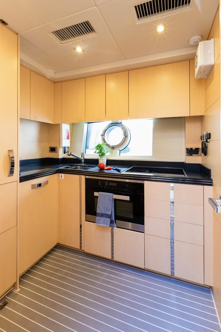 a kitchen with a tile floor aboard SKYFALL Yacht for Sale
