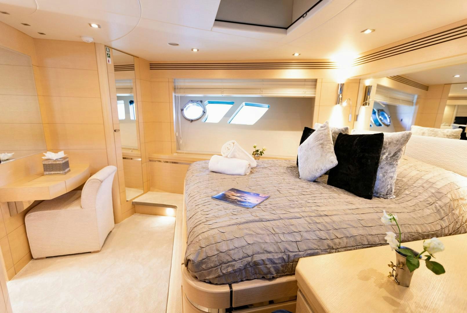 a bed with white pillows aboard SKYFALL Yacht for Sale