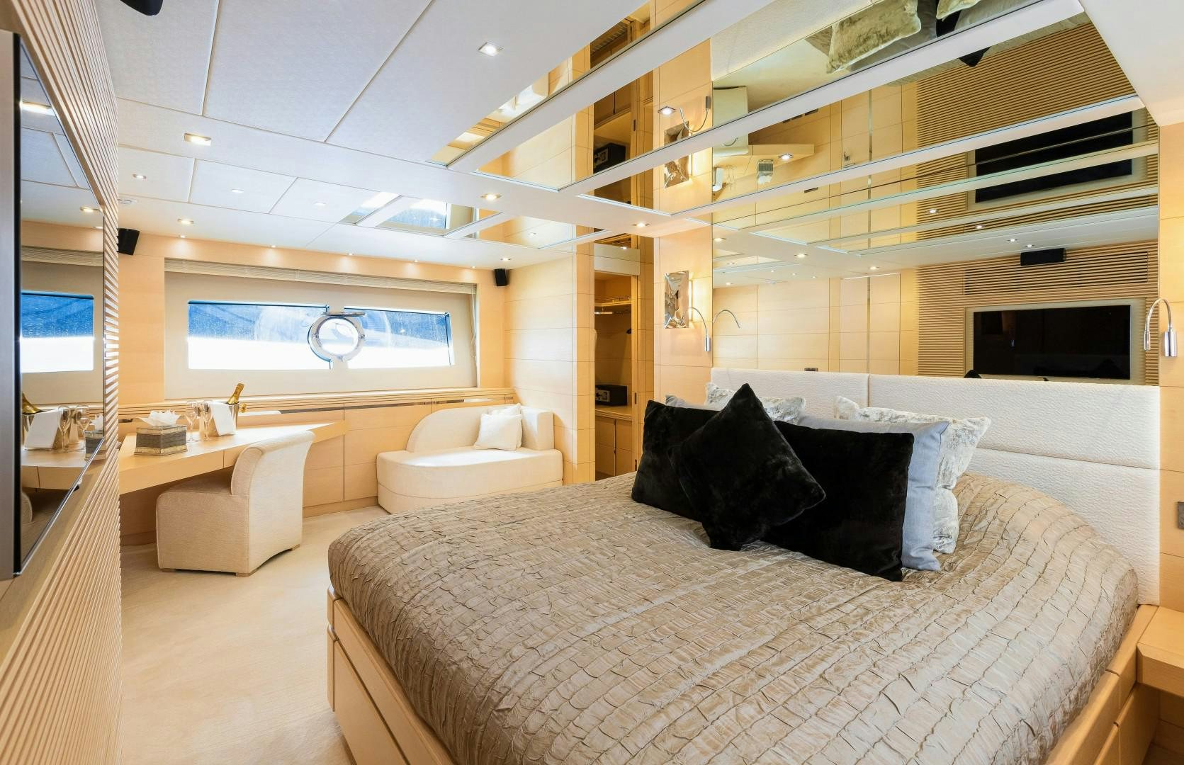a large bedroom with a bed and a tv aboard SKYFALL Yacht for Sale