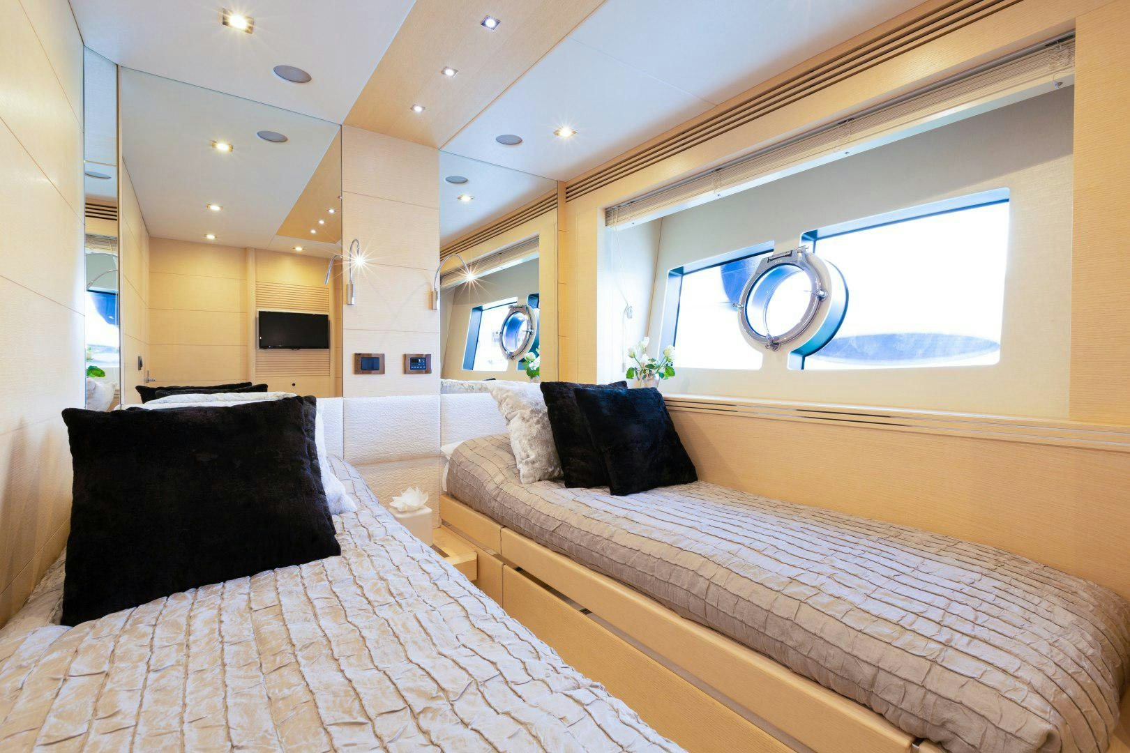 a room with a bed and a mirror aboard SKYFALL Yacht for Sale