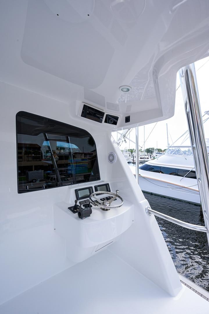 a boat with a steering wheel aboard BLACK SHADOW Yacht for Sale