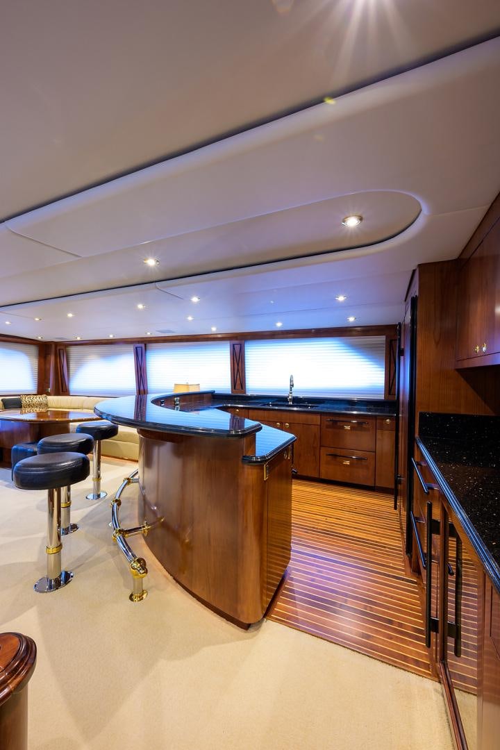 a room with a table and chairs aboard BLACK SHADOW Yacht for Sale