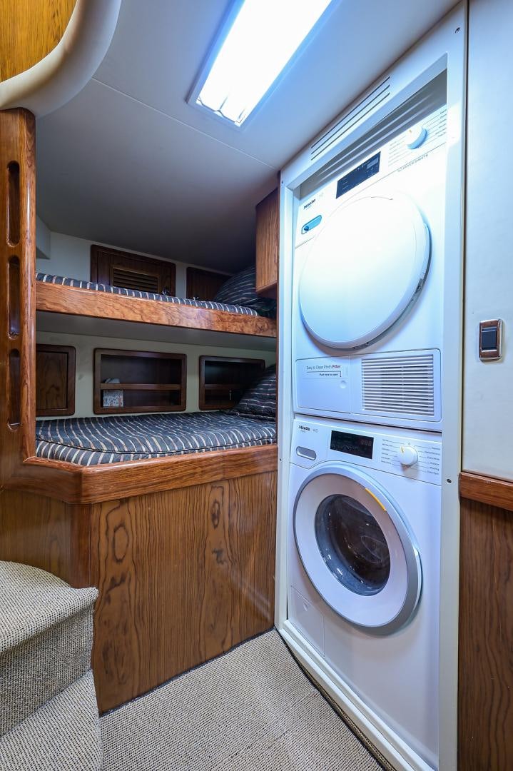 a washing machine in a room aboard BLACK SHADOW Yacht for Sale