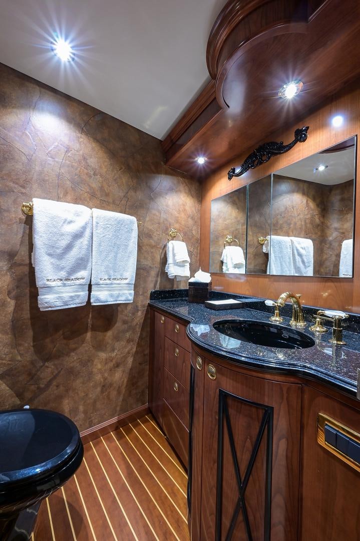 a bathroom with a sink and a mirror aboard BLACK SHADOW Yacht for Sale