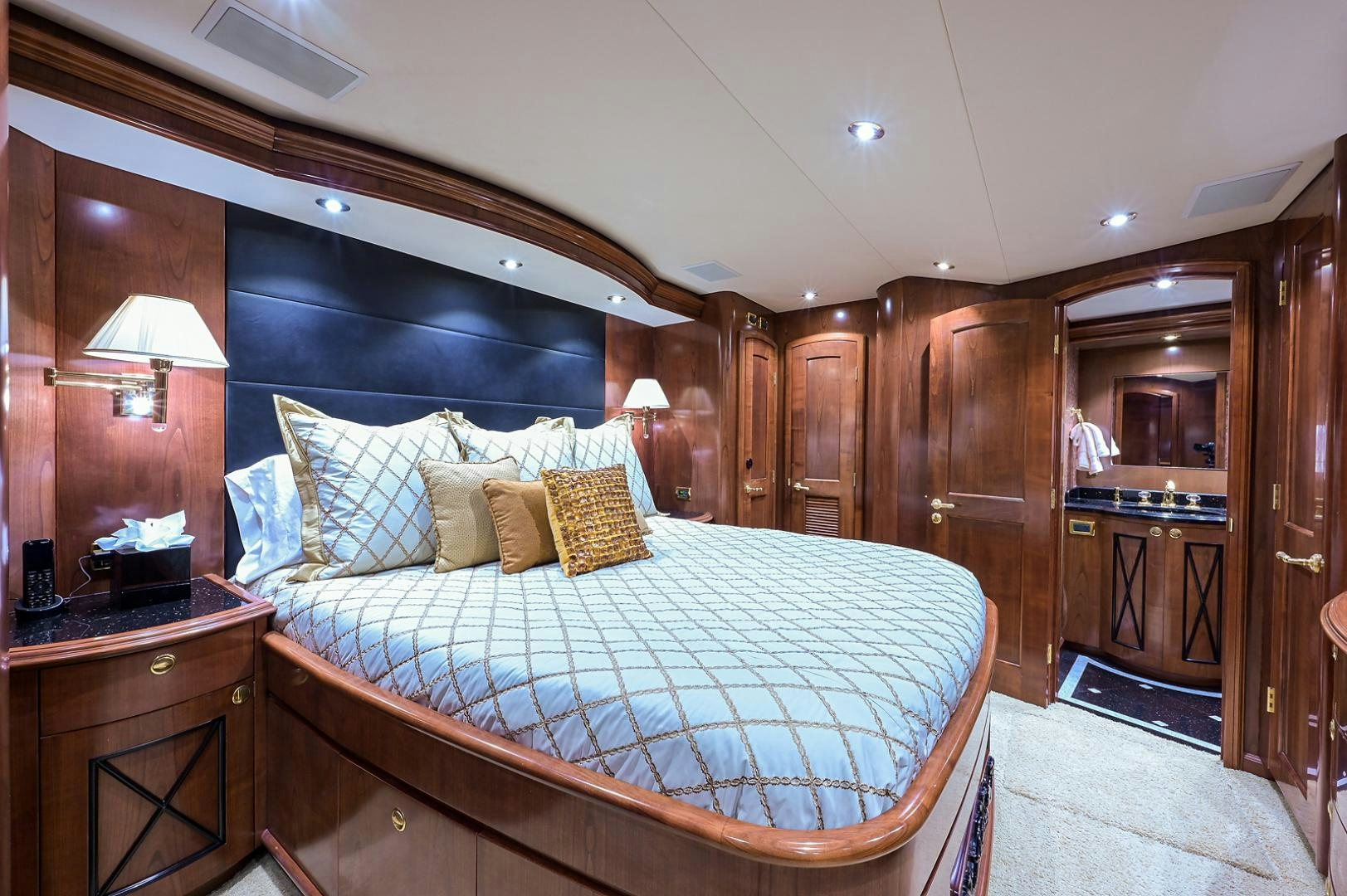 a bedroom with a bed and a desk aboard BLACK SHADOW Yacht for Sale