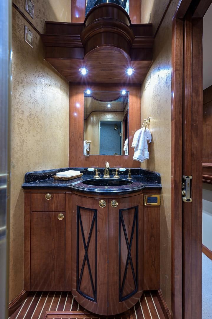a bathroom with a sink and a mirror aboard BLACK SHADOW Yacht for Sale