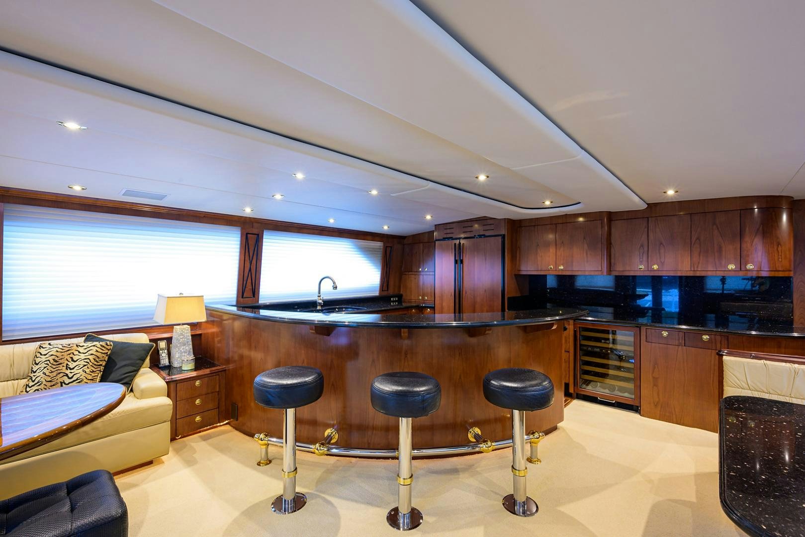 a kitchen with stools and stools aboard BLACK SHADOW Yacht for Sale